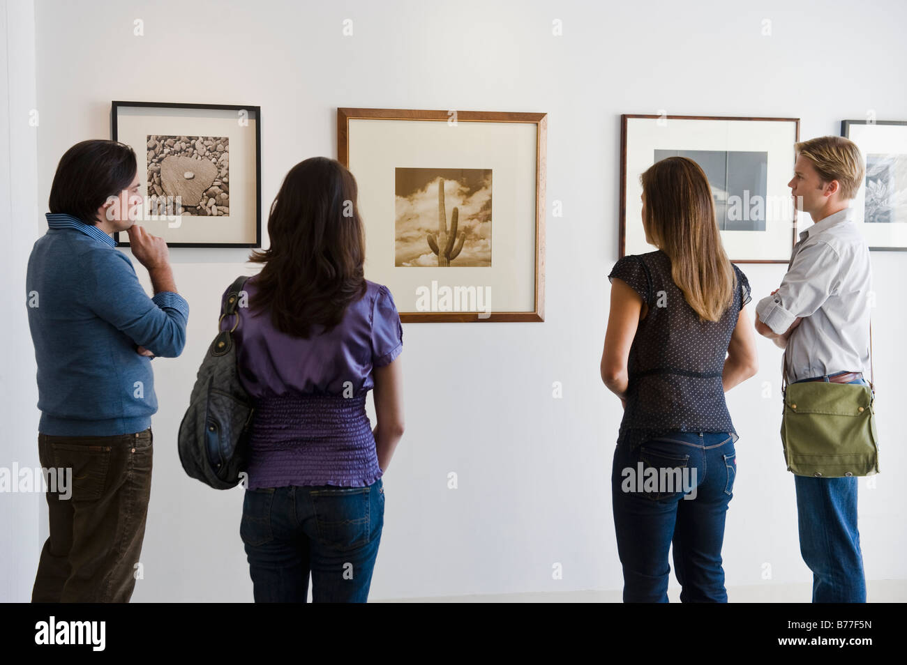 People looking pictures art gallery Stock Photo