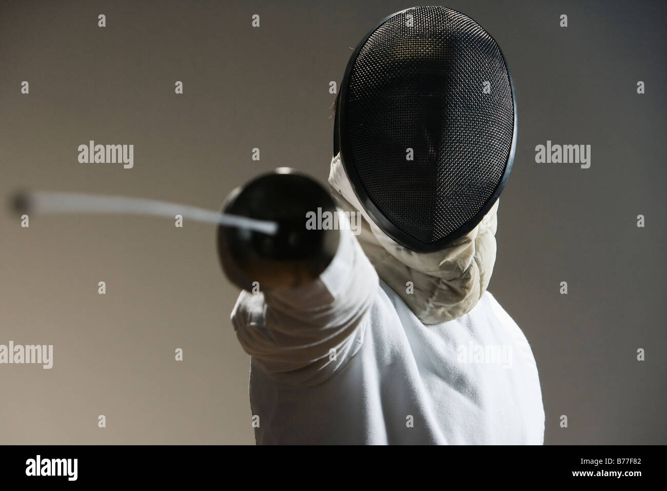 Close up of fencer mask pointing fencing foil Stock Photo