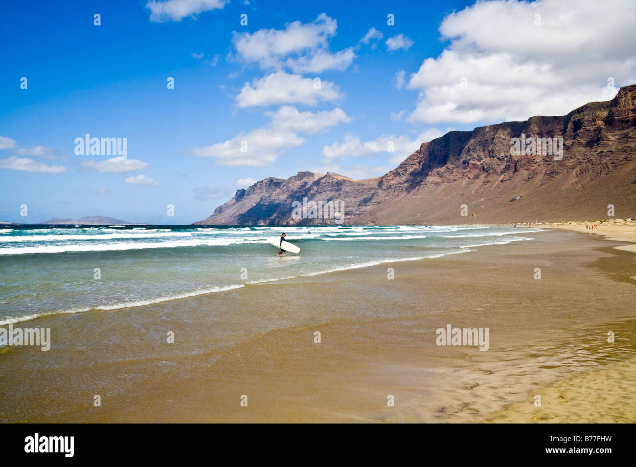 Playa de Famara risco de famara beach Mountain sand rocks reflection Lanzarote Canary Islands Spain Stock Photo