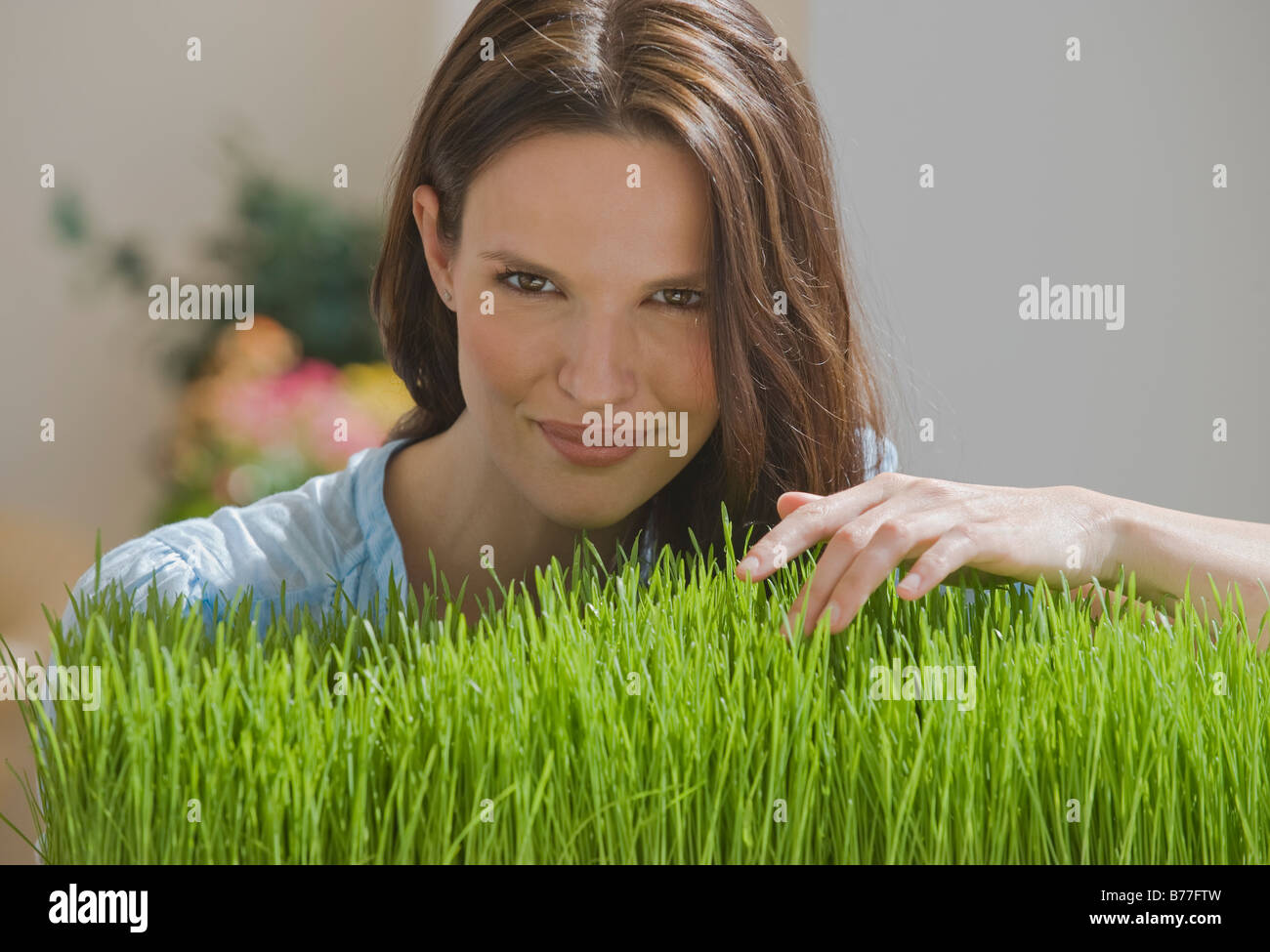 Portrait of woman touching grass Stock Photo - Alamy