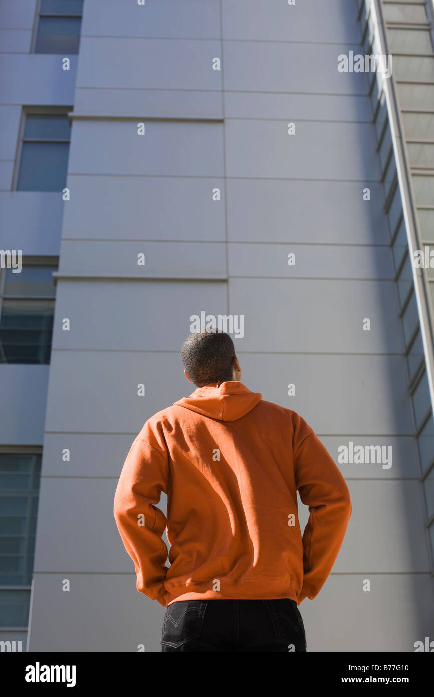 Man looking up highrise Stock Photo