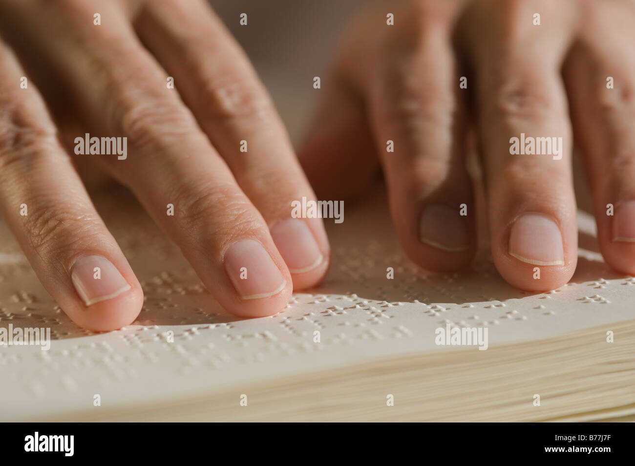 Close up of hand reading braille Stock Photo