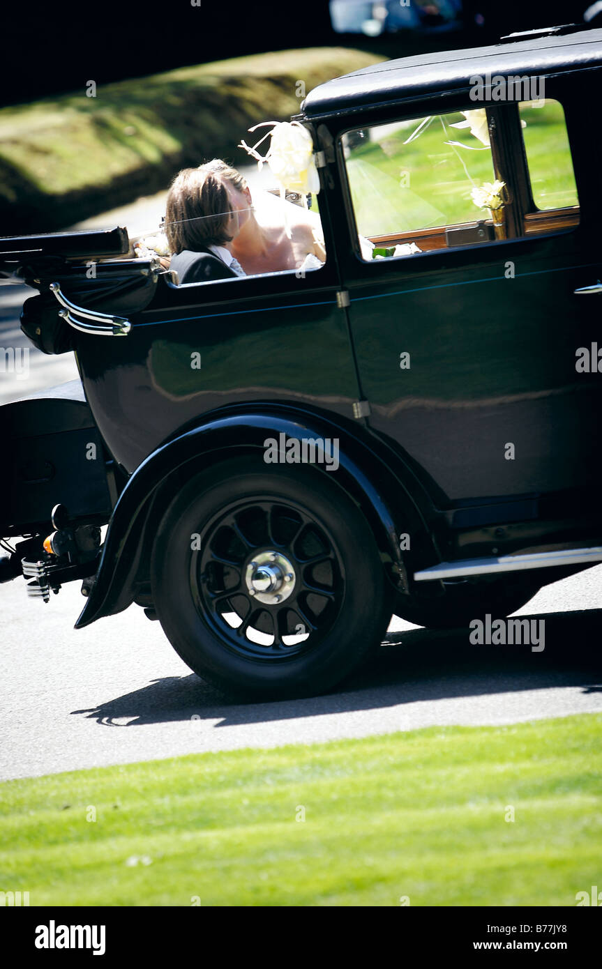 Bride and Groom in wedding car kissing Stock Photo - Alamy