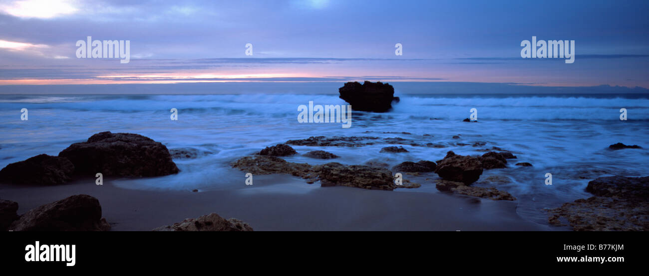 A weak Sunrise colours frontal Alto cloud as a new day dawns at Split Rock Point, Aireys Inlet, Victoria Australia Stock Photo