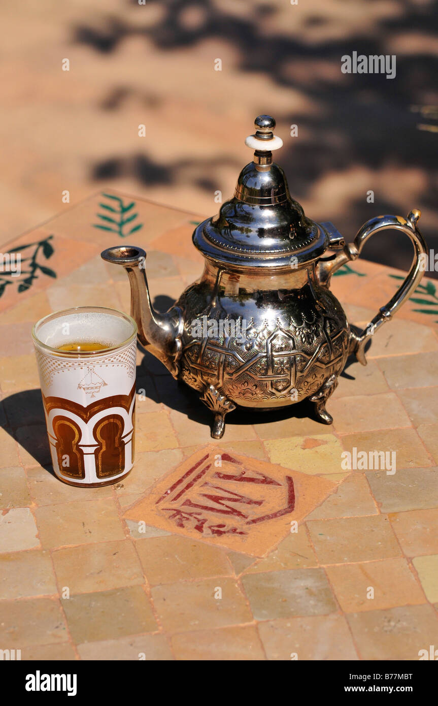 Silver teapot and tea glass with peppermint tea, Menara Gardens, Marrakech, Morocco, Africa Stock Photo