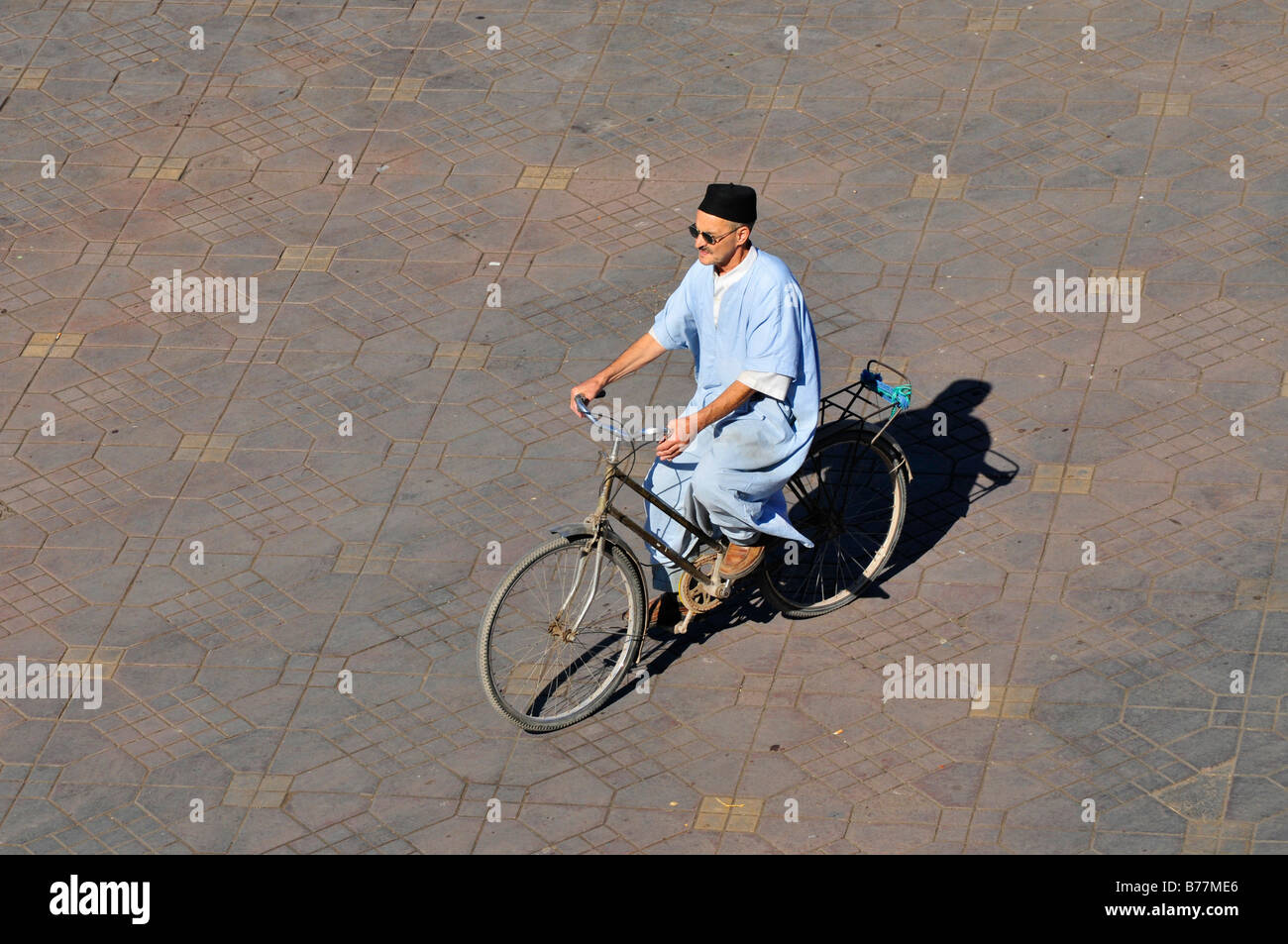 Cyclist in the Place Djemma el-Fna, Square of the hanged, imposter square, Marrakech, Morocco, Africa Stock Photo