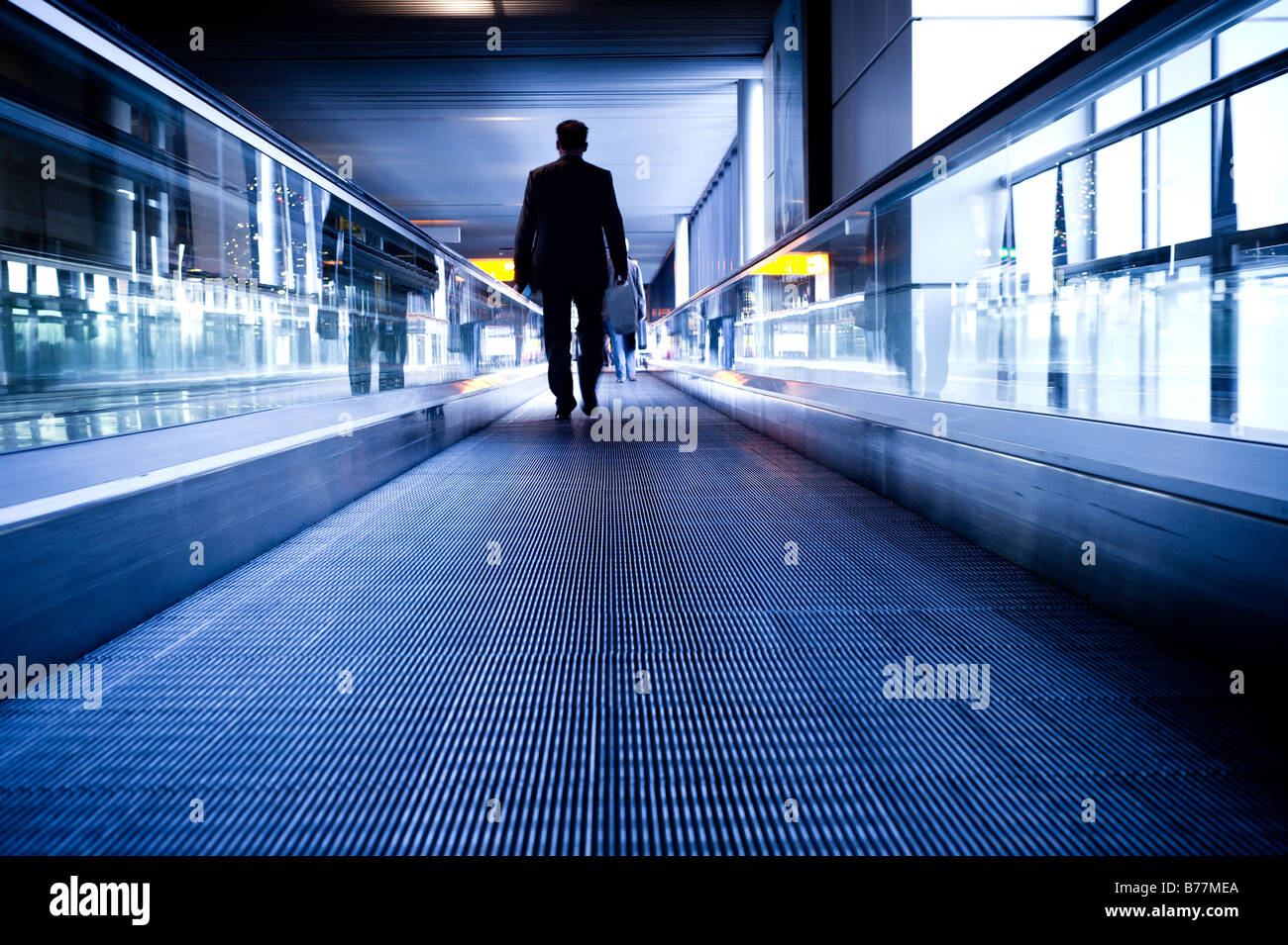 abstract travel image of a man on a moving escalator Stock Photo