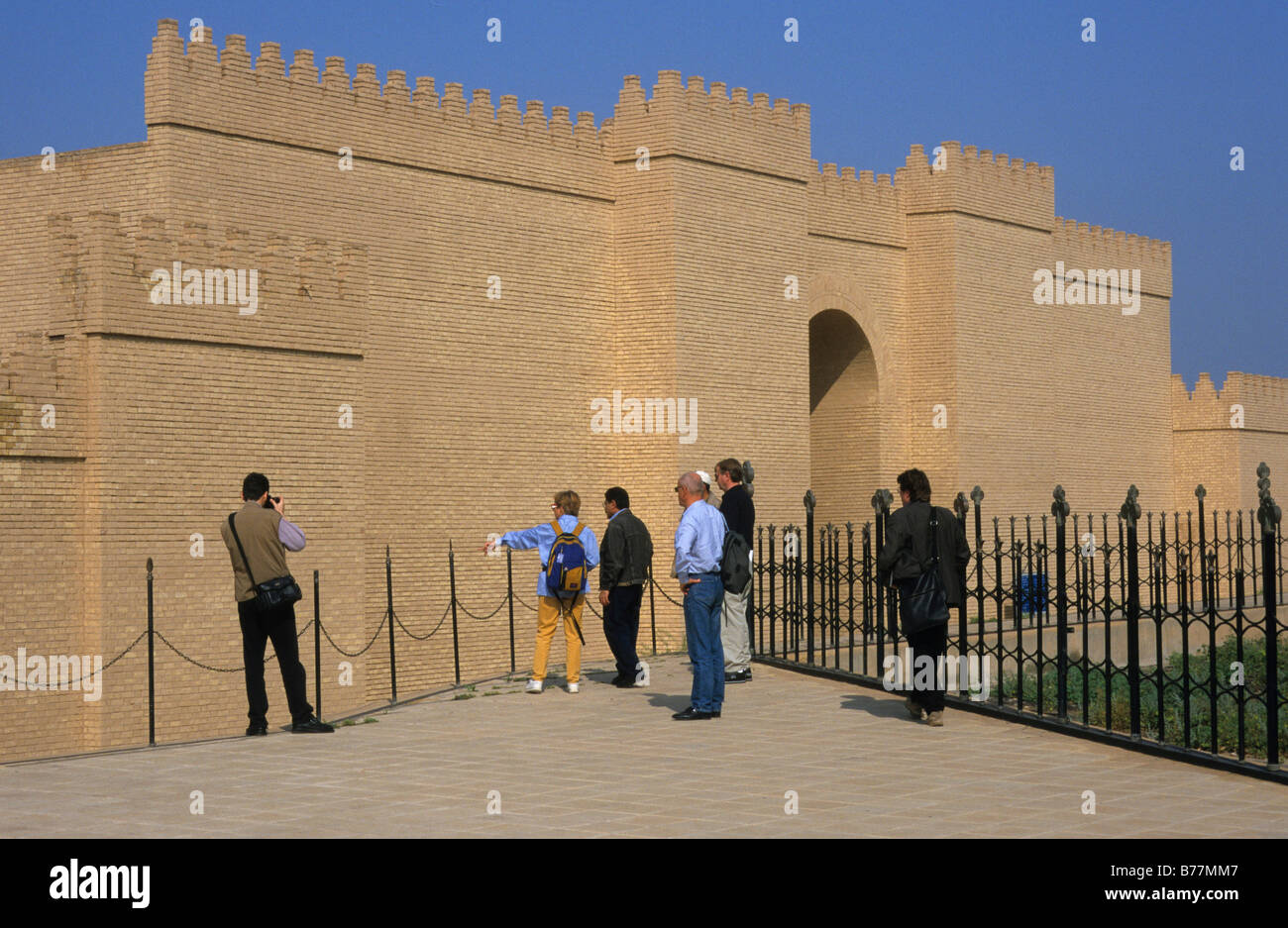 Tourists in front of a gate of the Royal Palace of Nebuchadnezzar II, reconstruction, Babylon, Iraq, Middle East Stock Photo