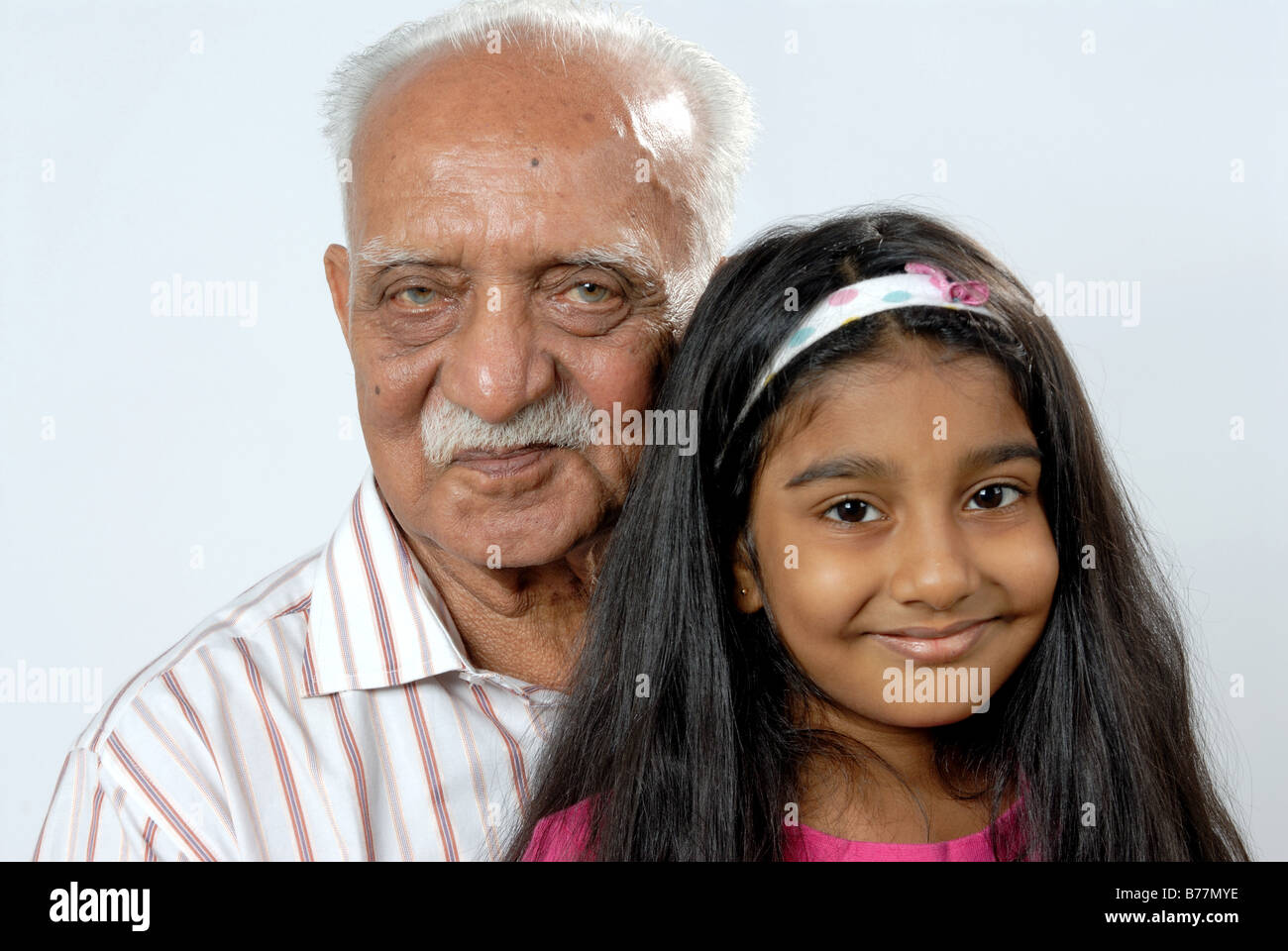 south-asian-indian-grandfather-and-granddaughter-looking-at-camera-mr