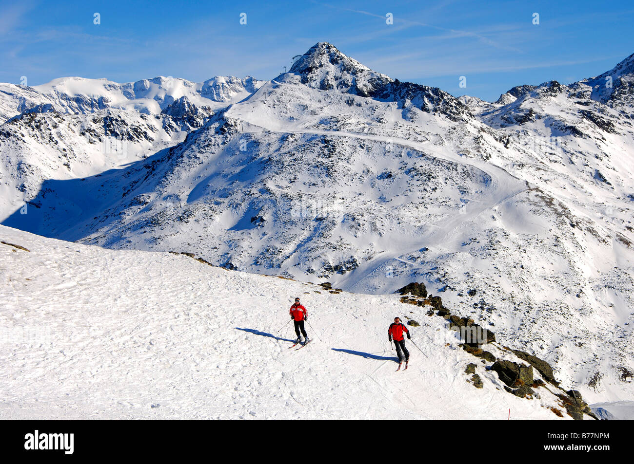 Skiers in front of the zig-zag shaped ski slope at Mont du Vallon, Meribel, skiing area Trois Vallees, France, Europe Stock Photo