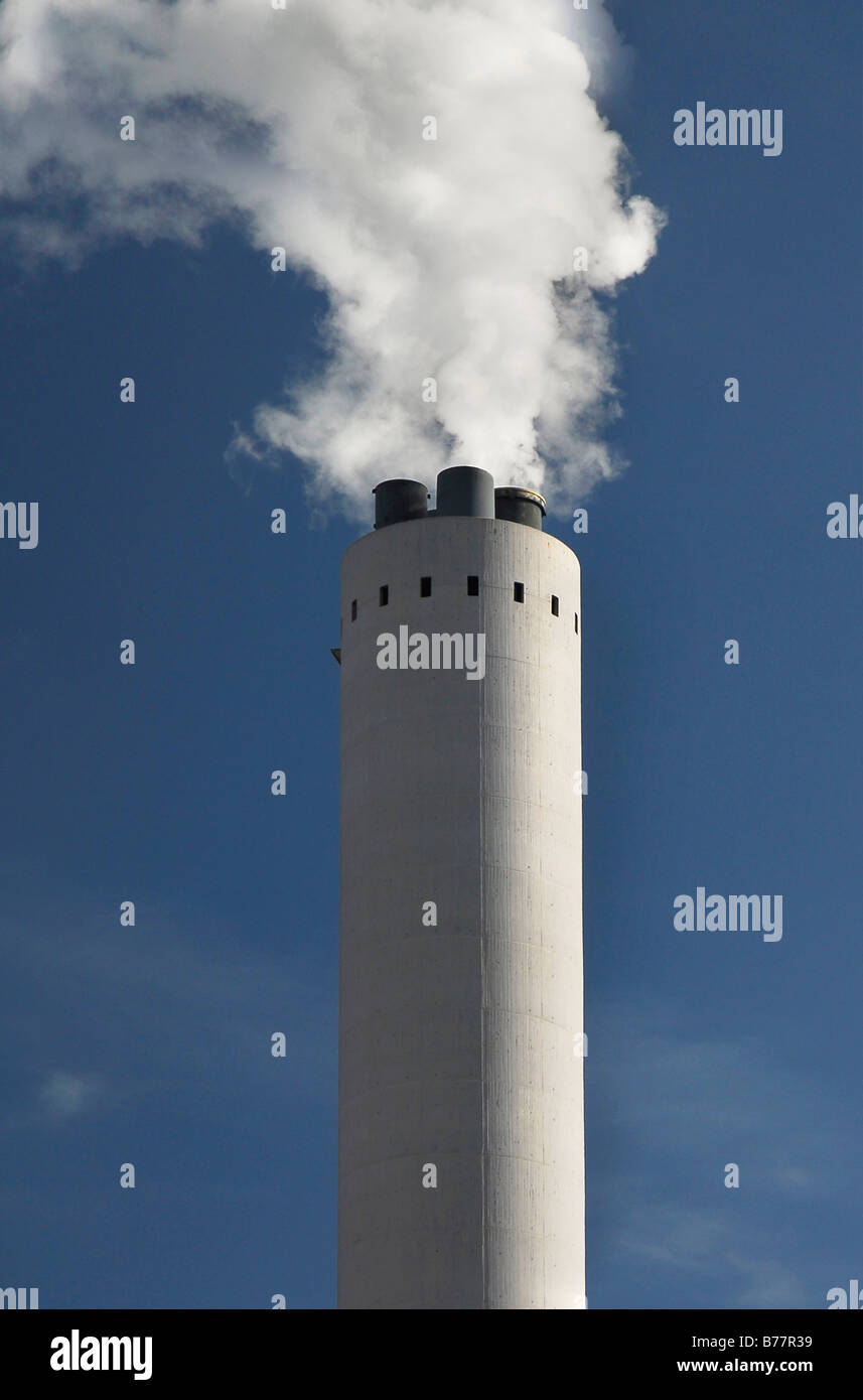 Industrial chimney spouting smoke into the sky, climate change, environmental pollution Stock Photo