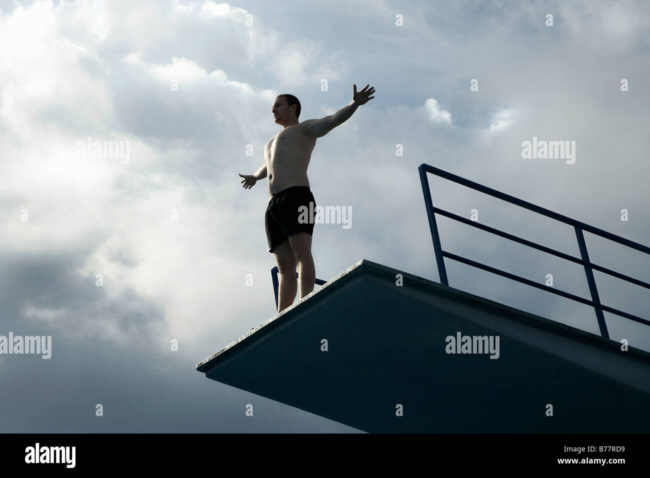 Young man standing on a diving tower Stock Photo