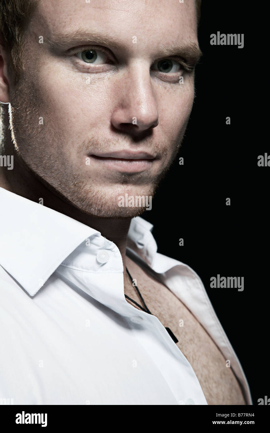 Portrait of a young man wearing a white shirt Stock Photo - Alamy