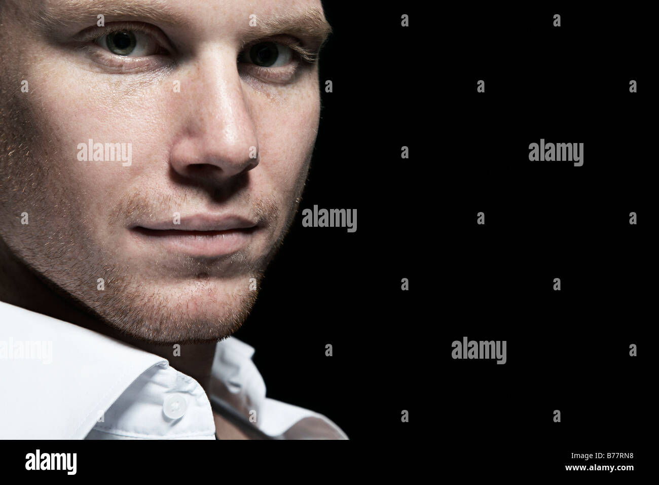 Portrait of a young man wearing a white shirt Stock Photo - Alamy