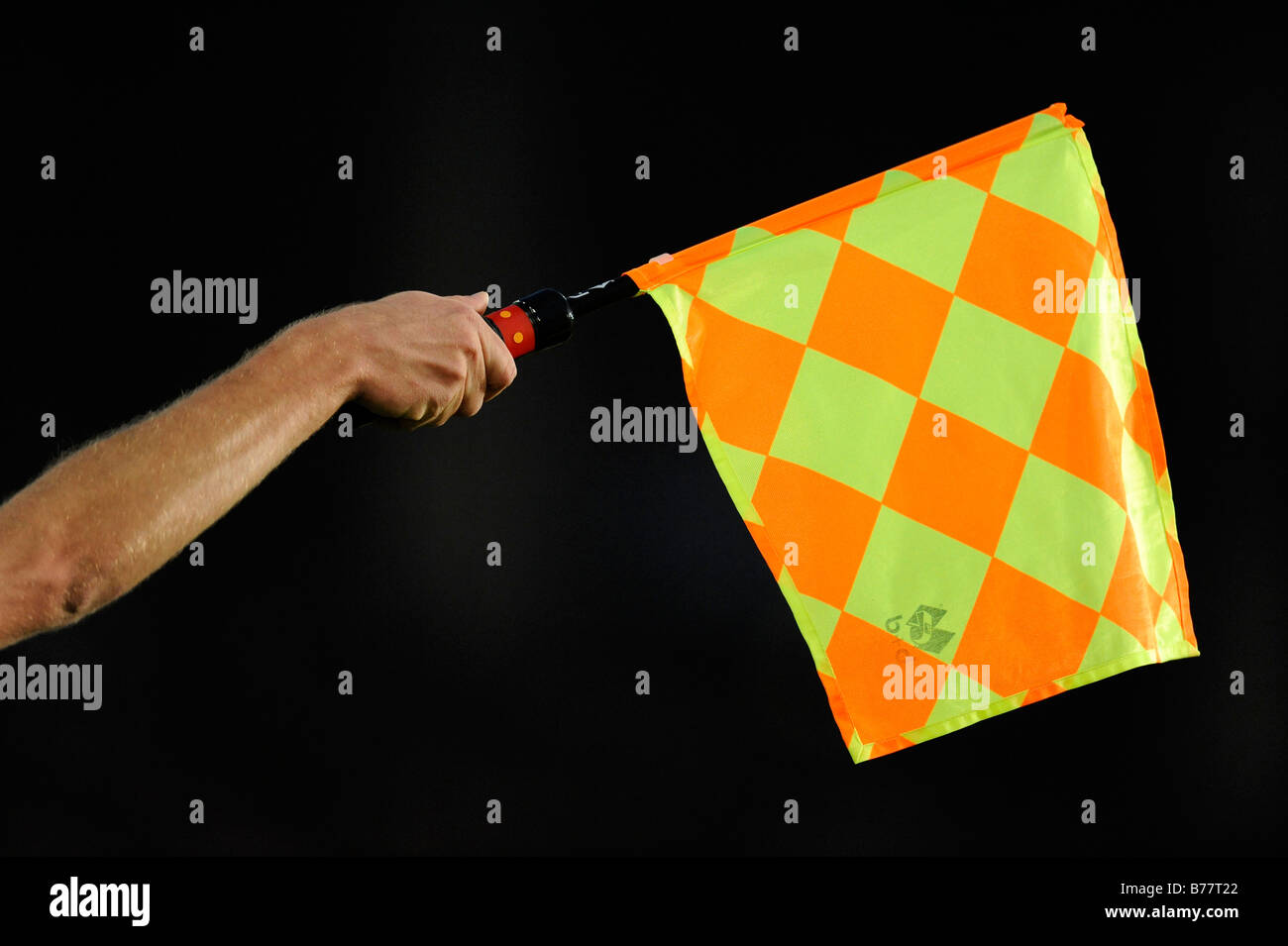 Flag indicating offside position, linesman's hand, assistant referee Stock Photo