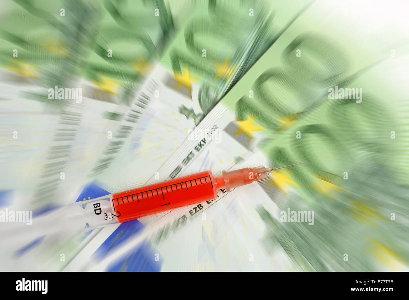 Syringe over 100 Euro banknotes, symbolic for a cash injection Stock Photo