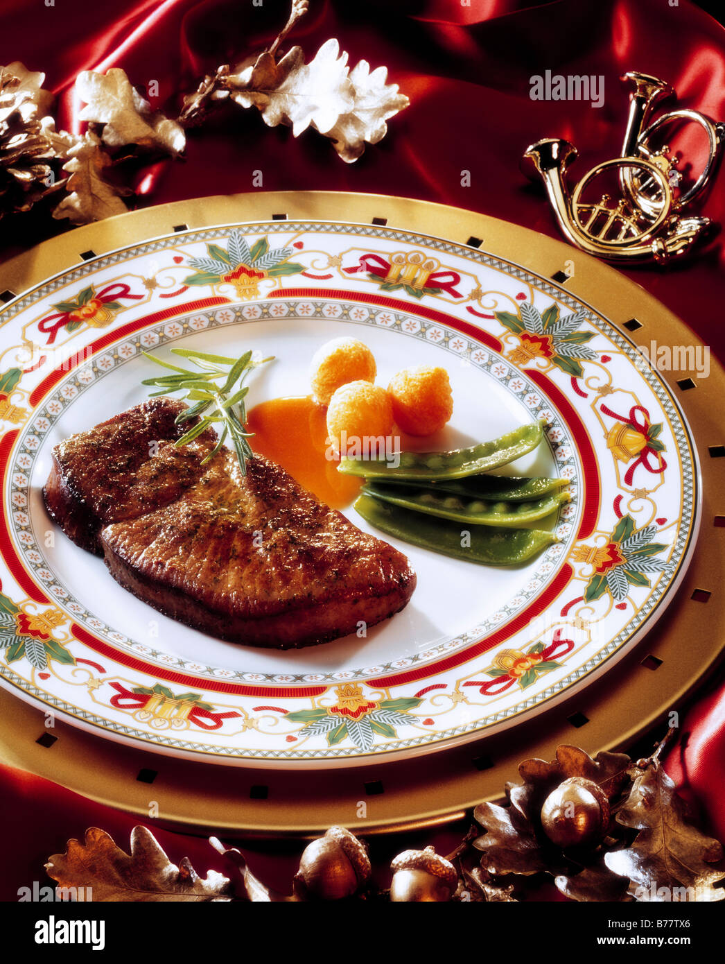 Venison steak with peas and croquettes Stock Photo