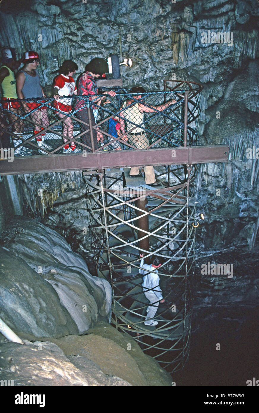 People going down spiral staircase Moaning Cave California Stock Photo