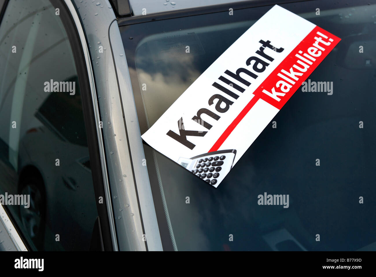 Sticker, Knallhart kalkuliert, tough calculated discounts, on a car Stock Photo