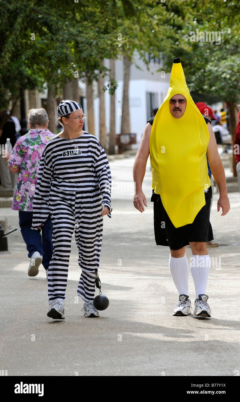 Dressed as a convict and a banana man and woman walking at Halloween in St Augustine Florida USA Stock Photo