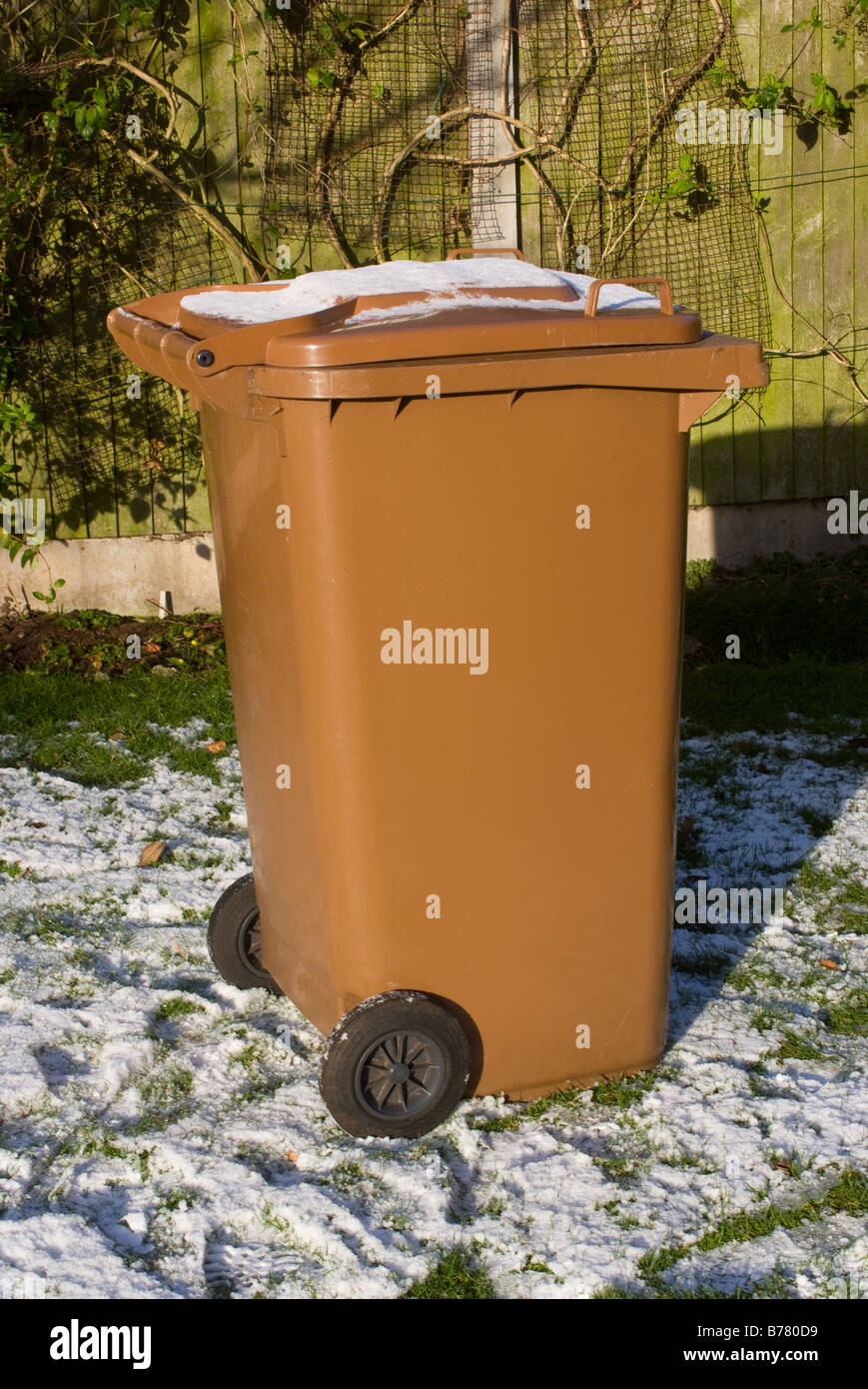 A Large Brown Garden Waste Wheelie Bin with Snow on Lid in a Cheshire  Garden England United Kingdom Stock Photo - Alamy