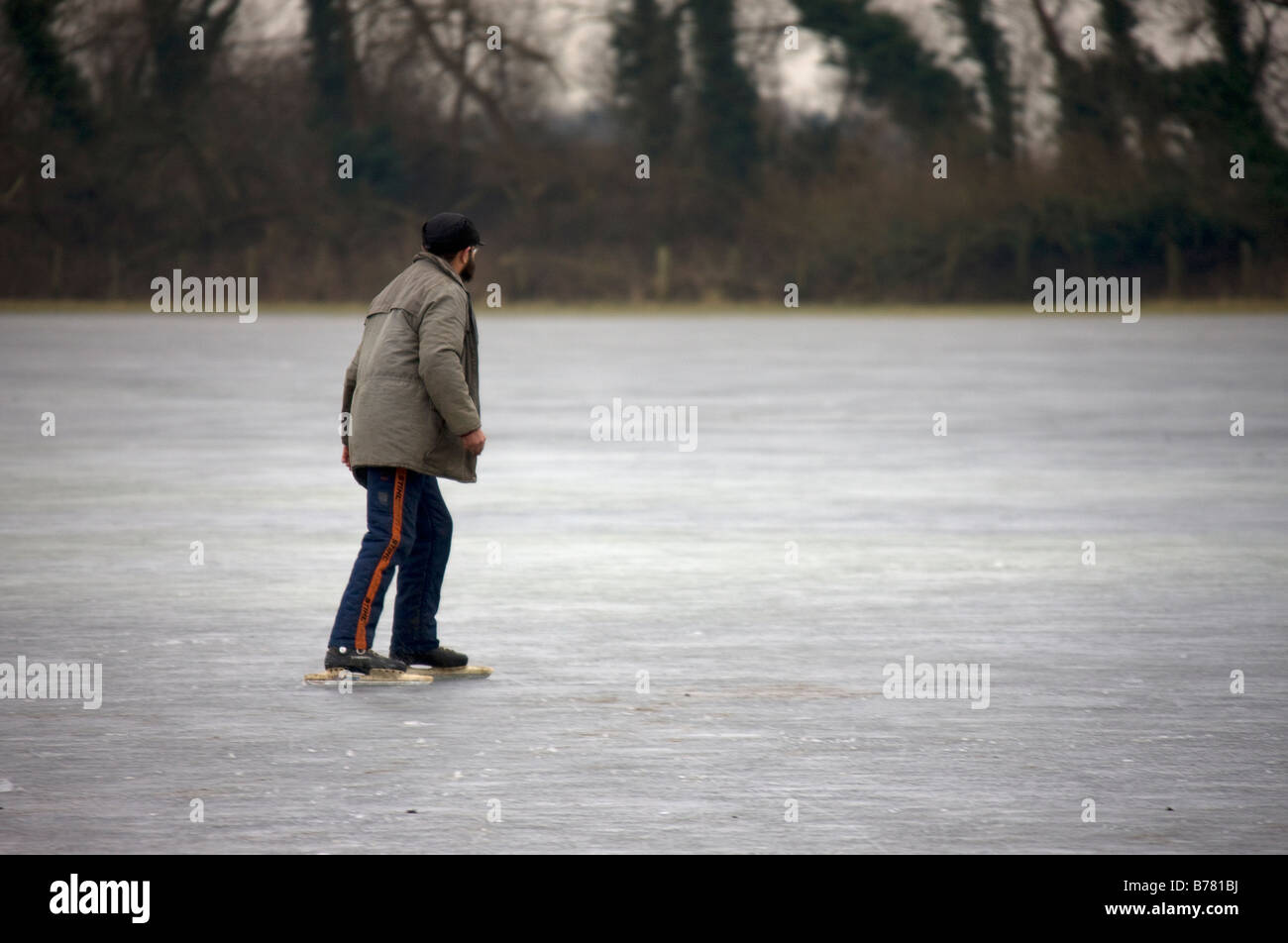 An infrequent opportunity to take advantage of the weather for some free skating on the local frozen fen. Stock Photo