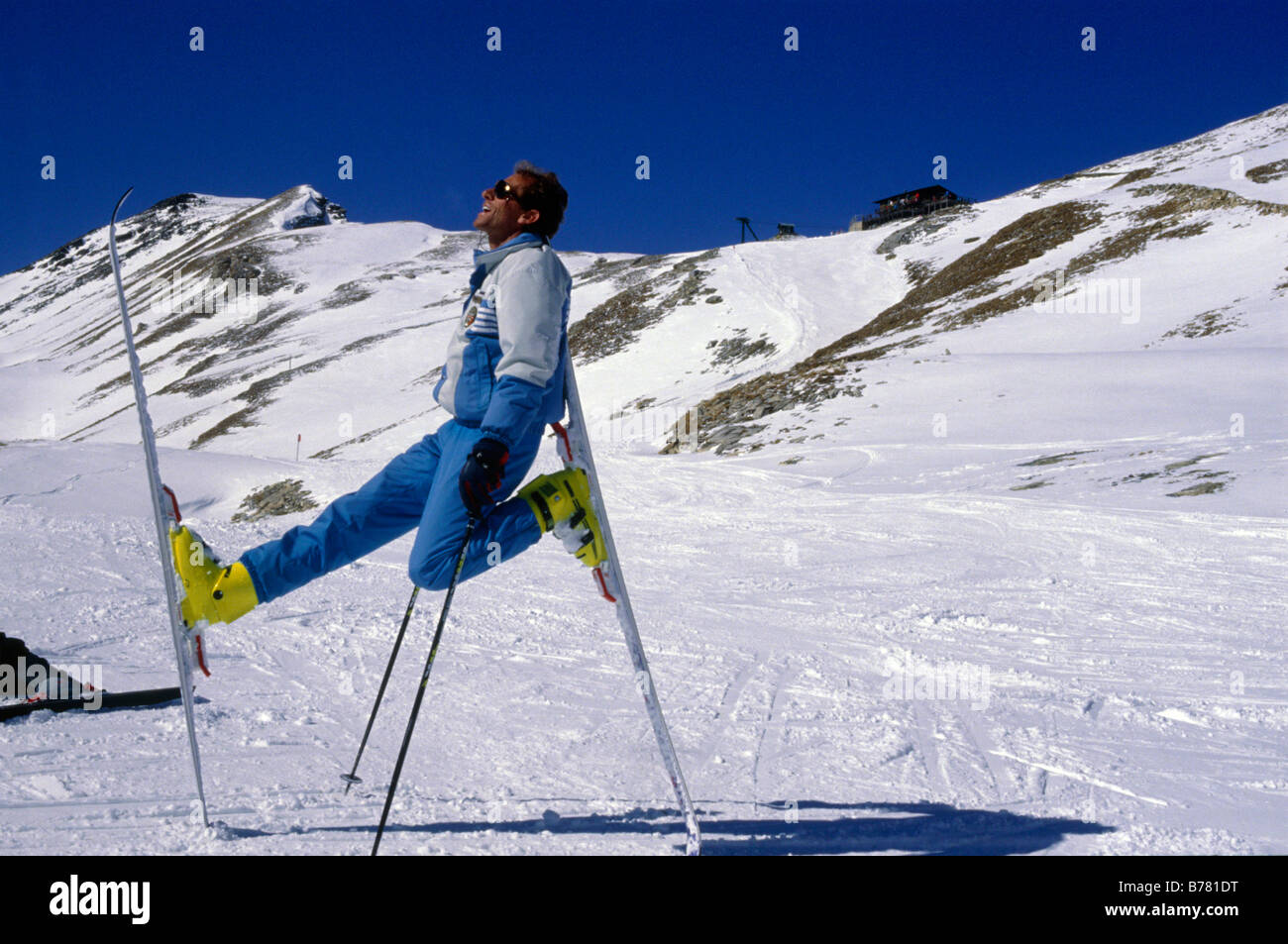 Ski instructor resting on his skis SANTA CATERINA LOMBARDY ITALY Stock Photo
