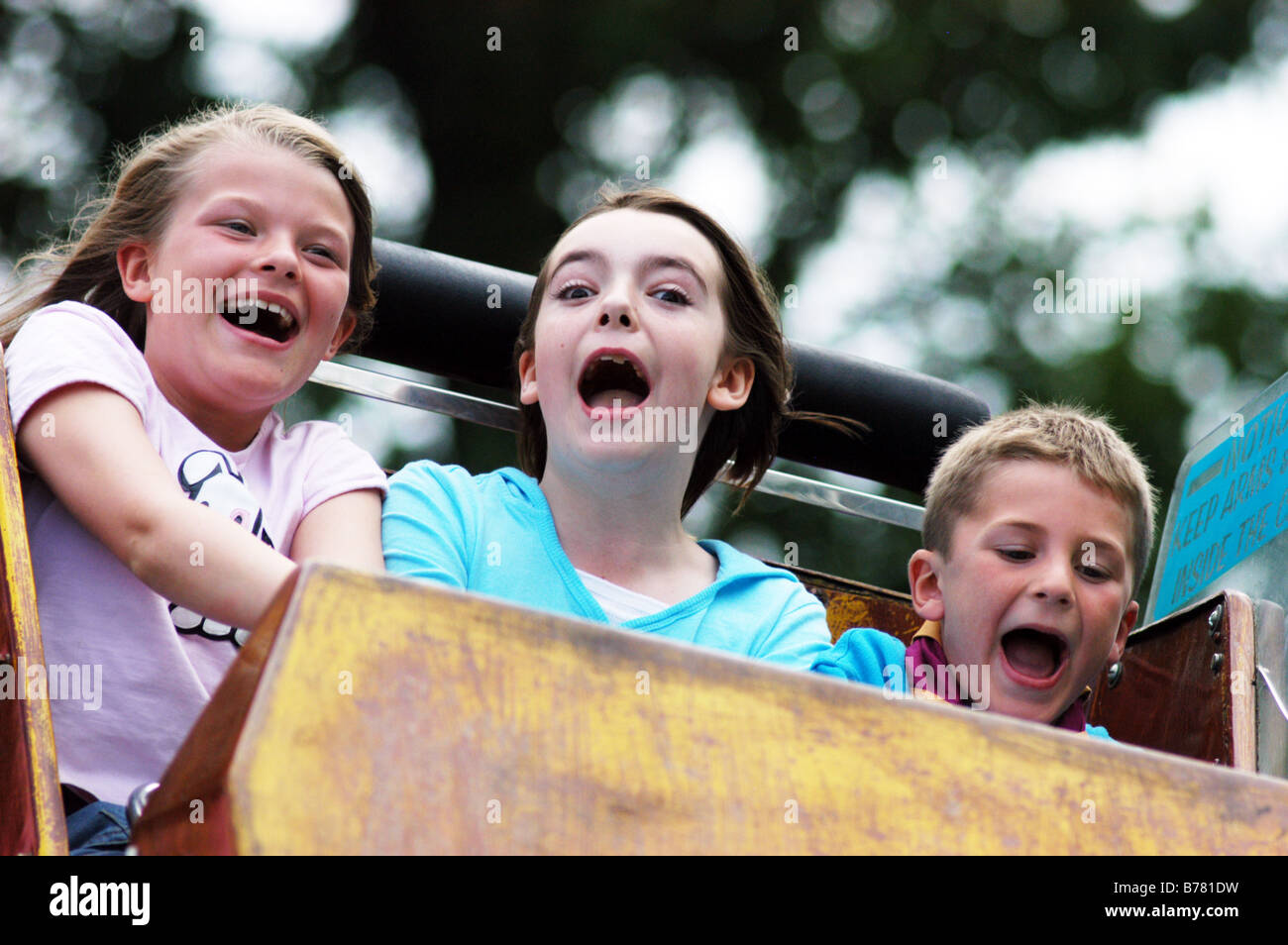 Children scream while riding on a fairground ride North Yorkshire, Model released Stock Photo