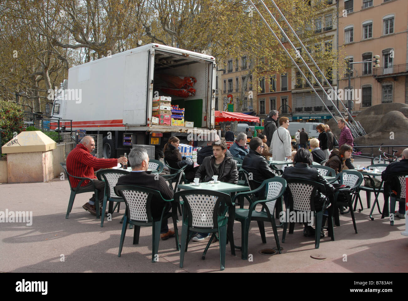 Market traders and customers enjoying having a refreshments on Quai St