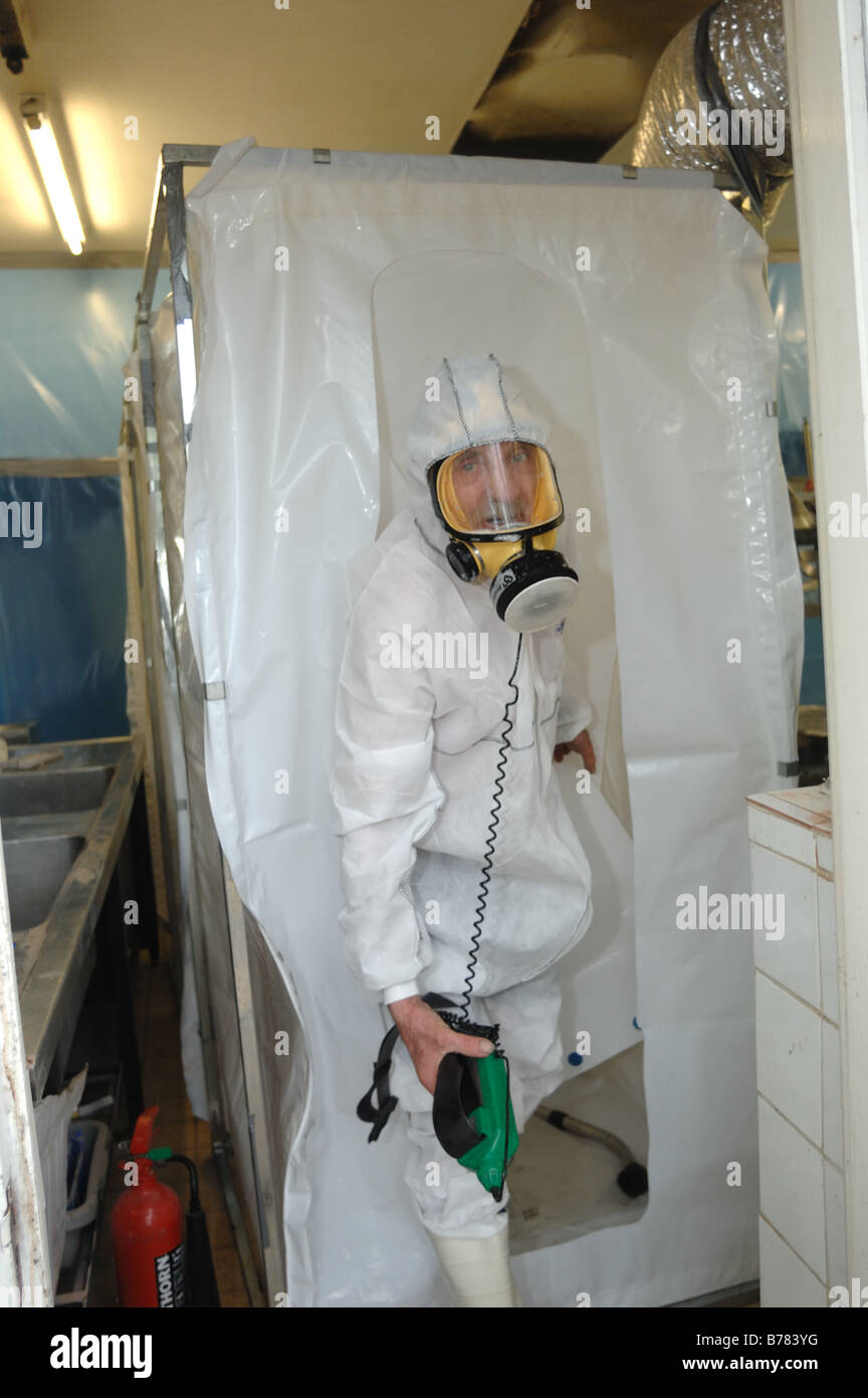 Man dressed in full protective clothing entering a secured environment