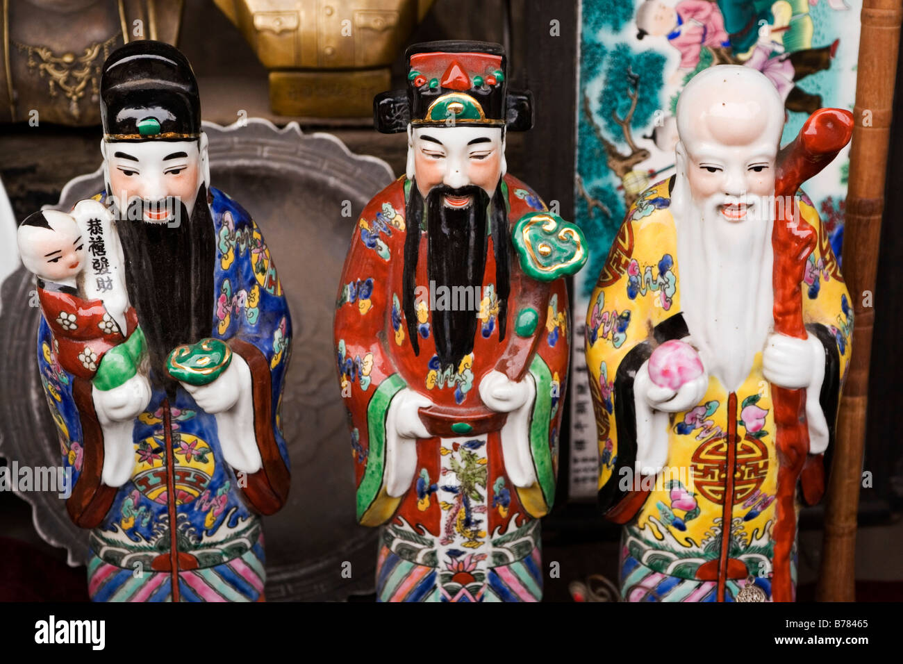Porcelain Confucious figures are sold on a market stall in the Chinese city of Pingyao in Shanxi Province. Stock Photo