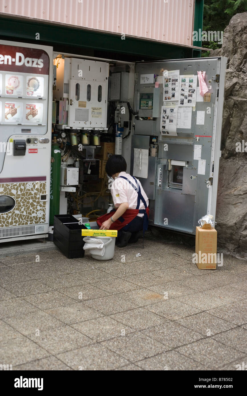 person cleaning and restocking vending machine Stock Photo Alamy
