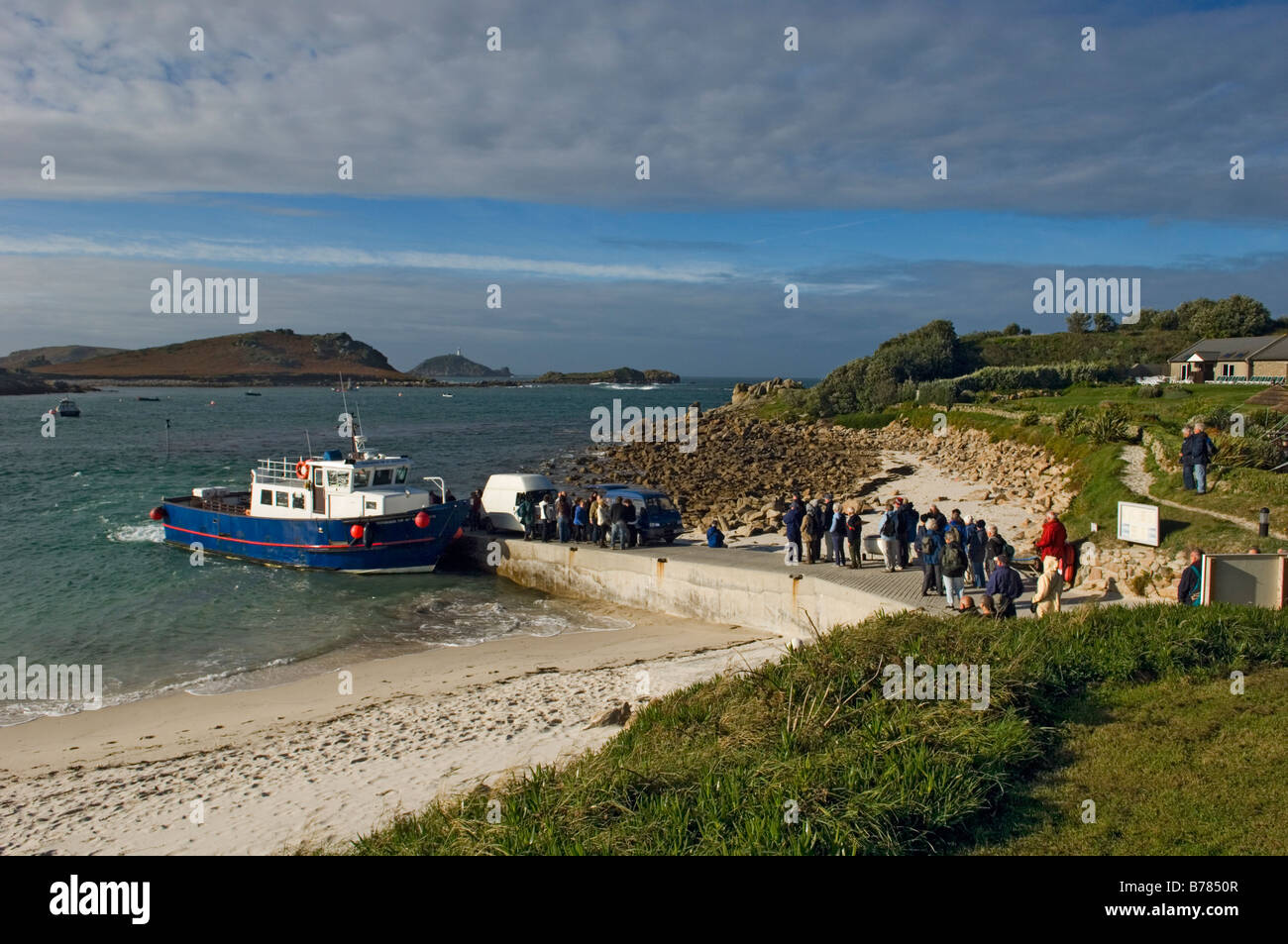 Queuing tourists boarding the Island ferry. Lower Town Quay, St Martin's, The Isles of Scilly, Cornwall, England, UK Stock Photo