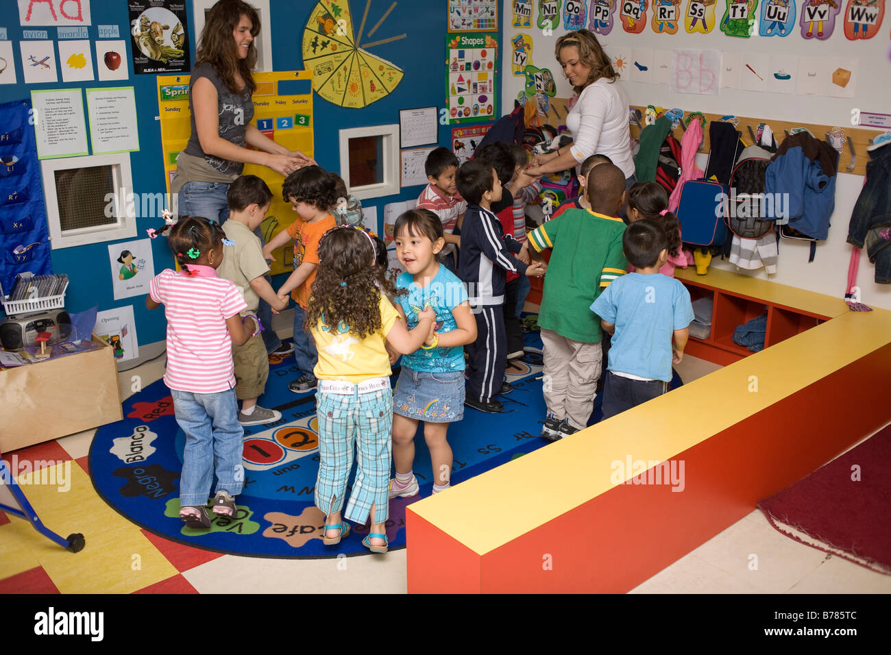 Preschool children dancing in classroom hi-res stock photography and