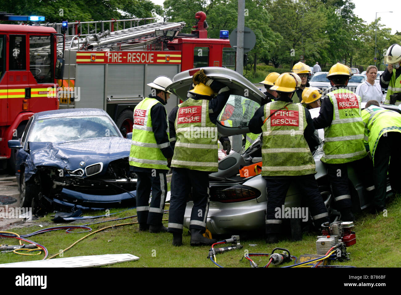 Fire Fighters extricating a driver using cutting gear Stock Photo