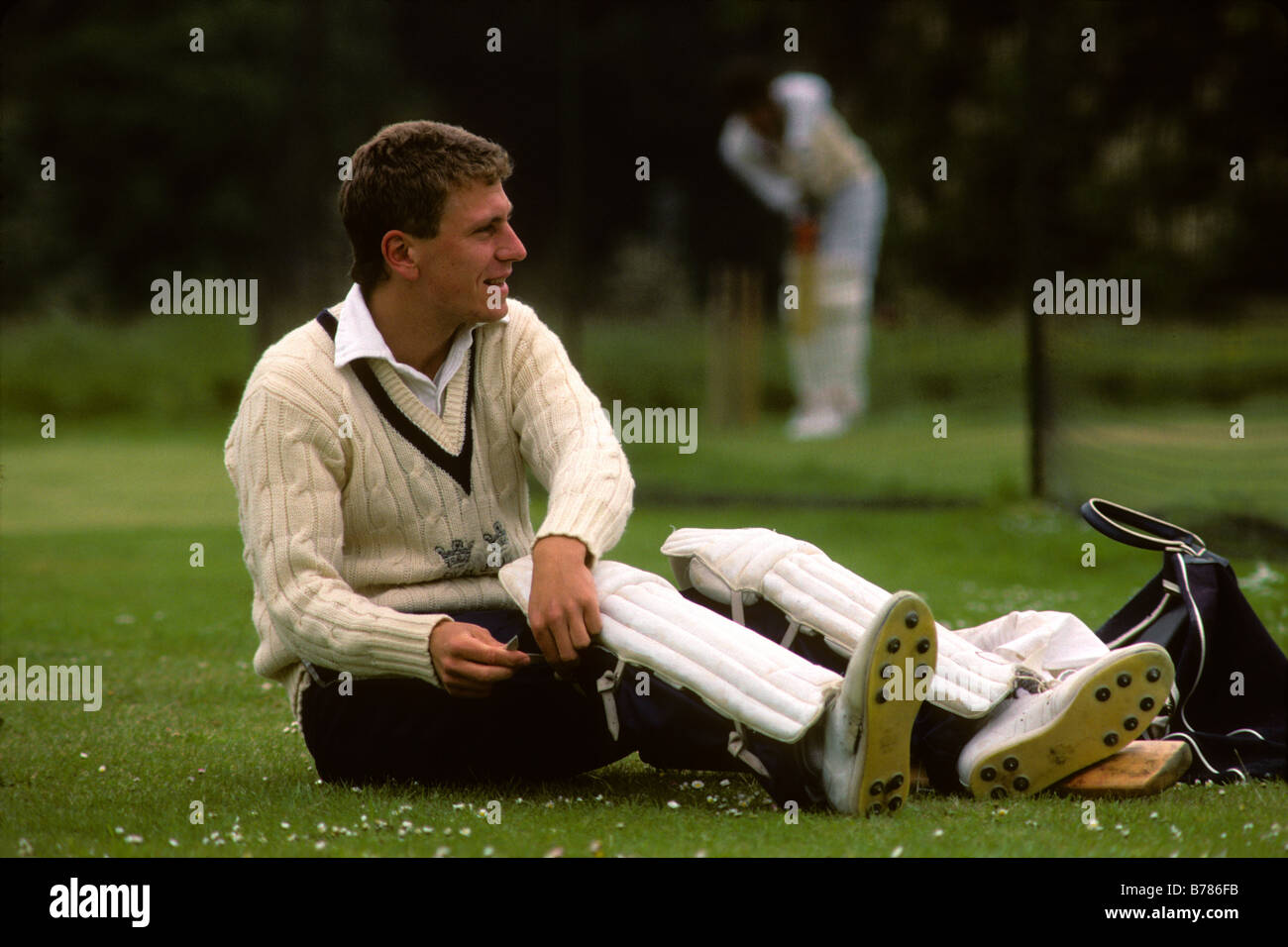'Oxford, UK. Oxford University student puts on cricket pads as he prepares to play for his university team.' Stock Photo