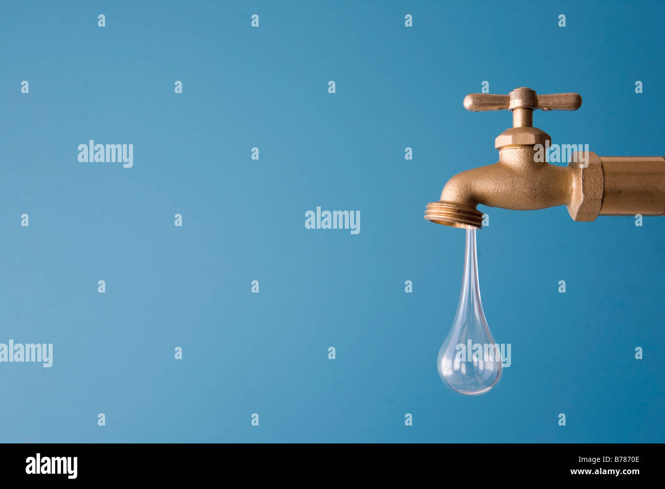 giant drop of water drips from faucet Stock Photo