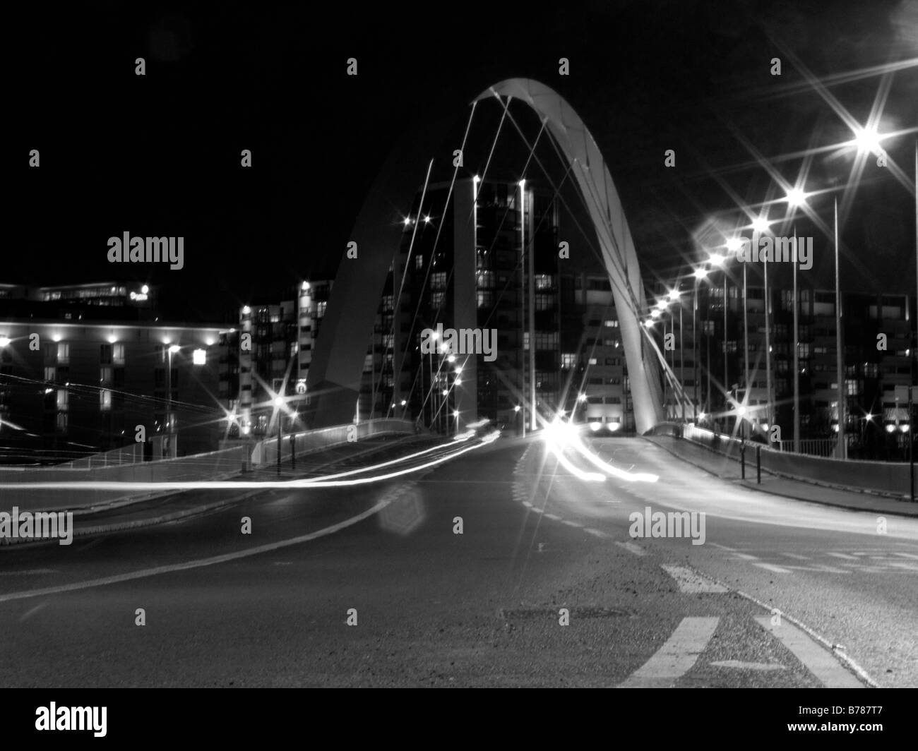 Black and White photograph of Clyde Arc bridge over the river Clyde and passing by car lights in Glasgow, Scotland Stock Photo