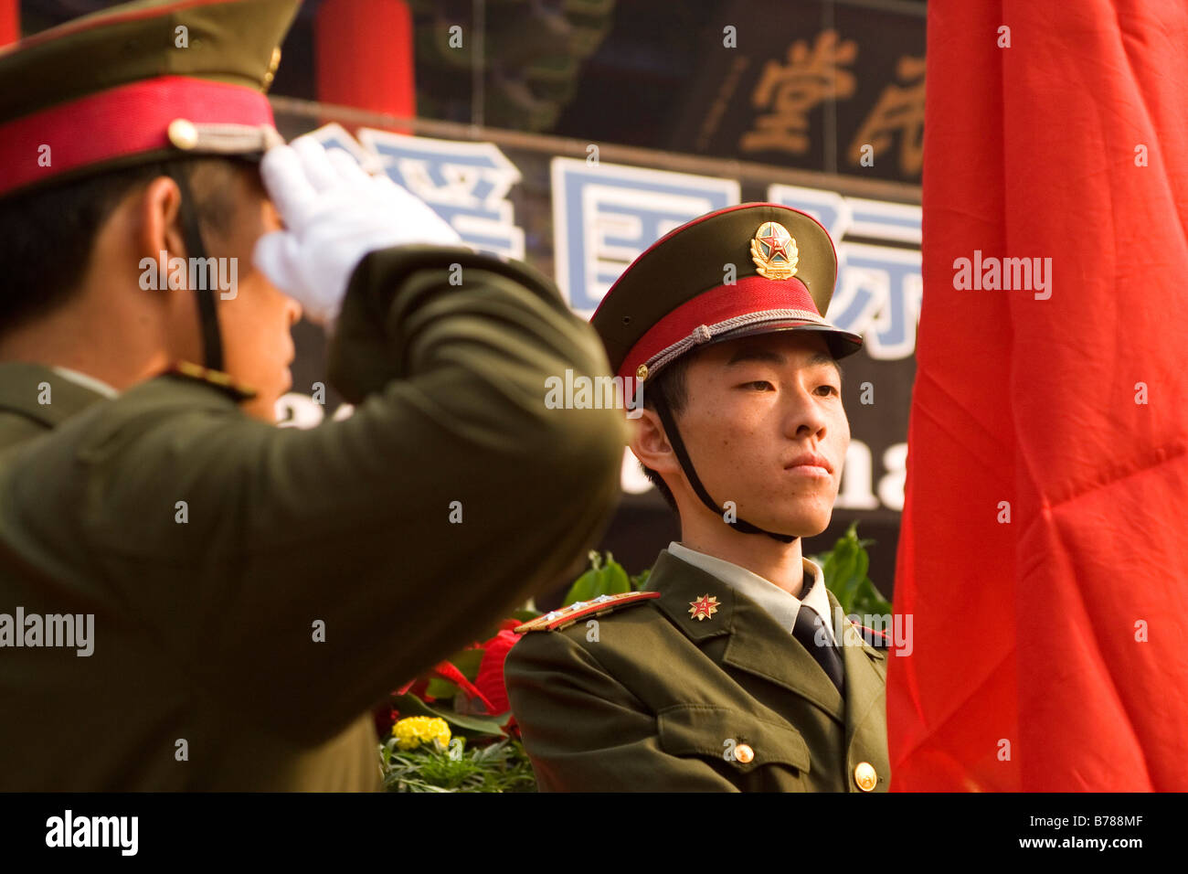 Chinese soldiers salute the flag during a flag raising ceremony in the Chinese city of Pingyao in Shanxi Province. Stock Photo
