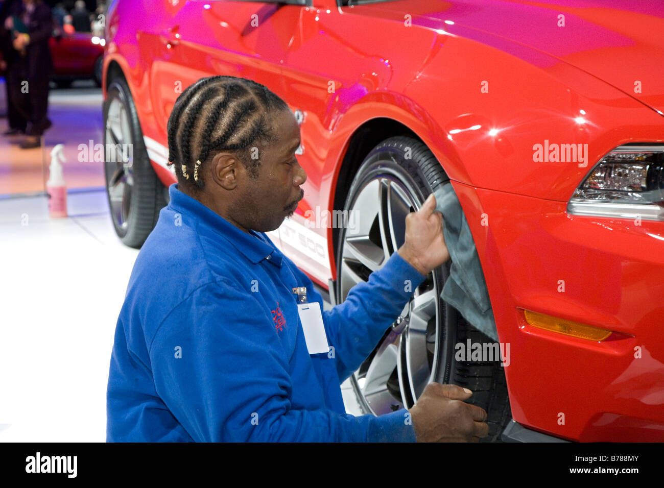 Detroit Michigan A worker polishes the Ford Mustang GT 500 at the North American International Auto Show Stock Photo
