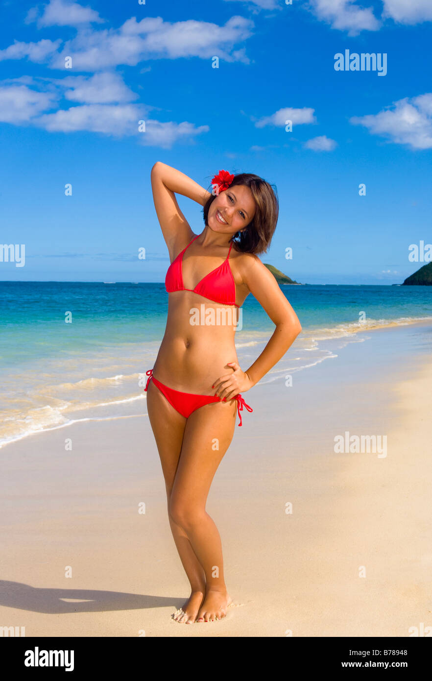 a beautiful young Polynesian girl in a red bikini on a Hawaii beach