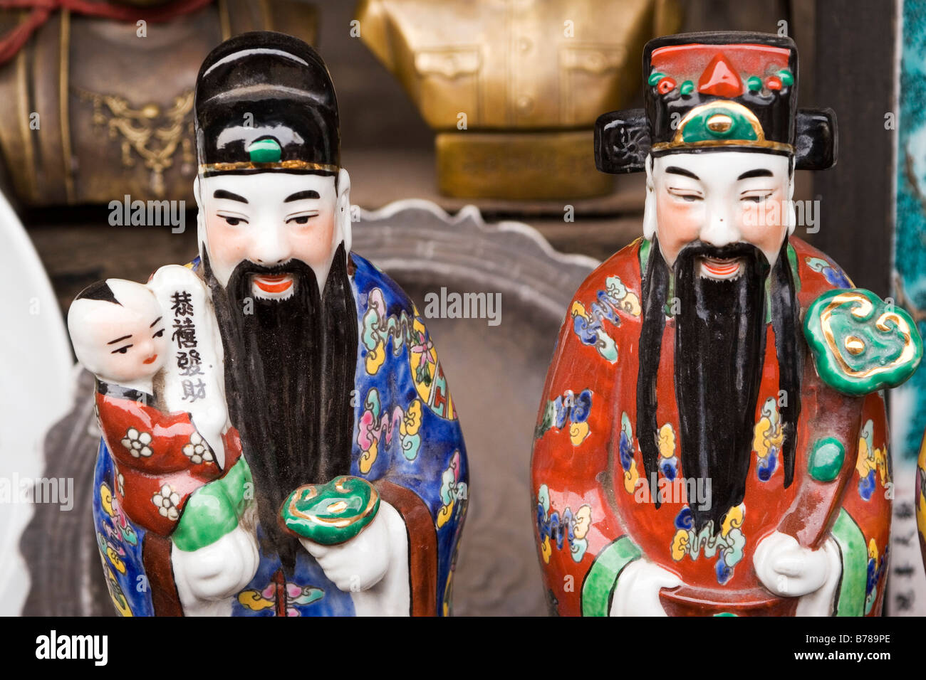 Porcelain Confucius figures are sold on a market stall in the Chinese city of Pingyao in Shanxi Province. Stock Photo