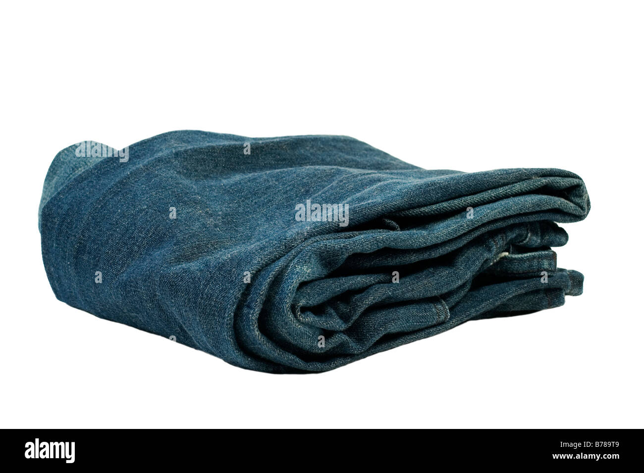 Isolated folded blue jeans against white background Stock Photo - Alamy