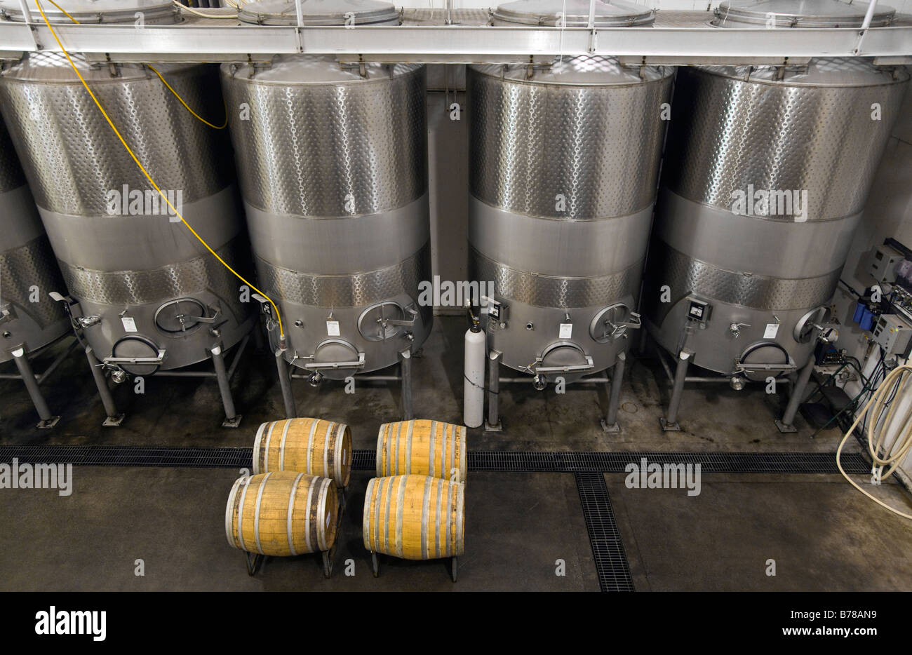 STAINLESS STEEL WINE TANKS and OAK BARRELS are used to age wine at JOULLIAN  VINEYARDS CARMEL VALLEY CALIFORNIA Stock Photo - Alamy