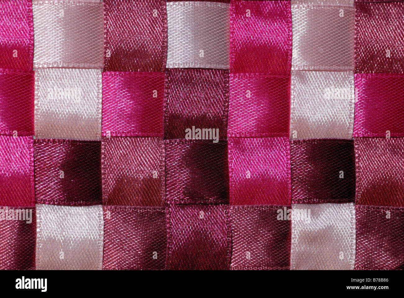 Pink ribbon of varying colors woven into a checkerboard pattern. Stock Photo