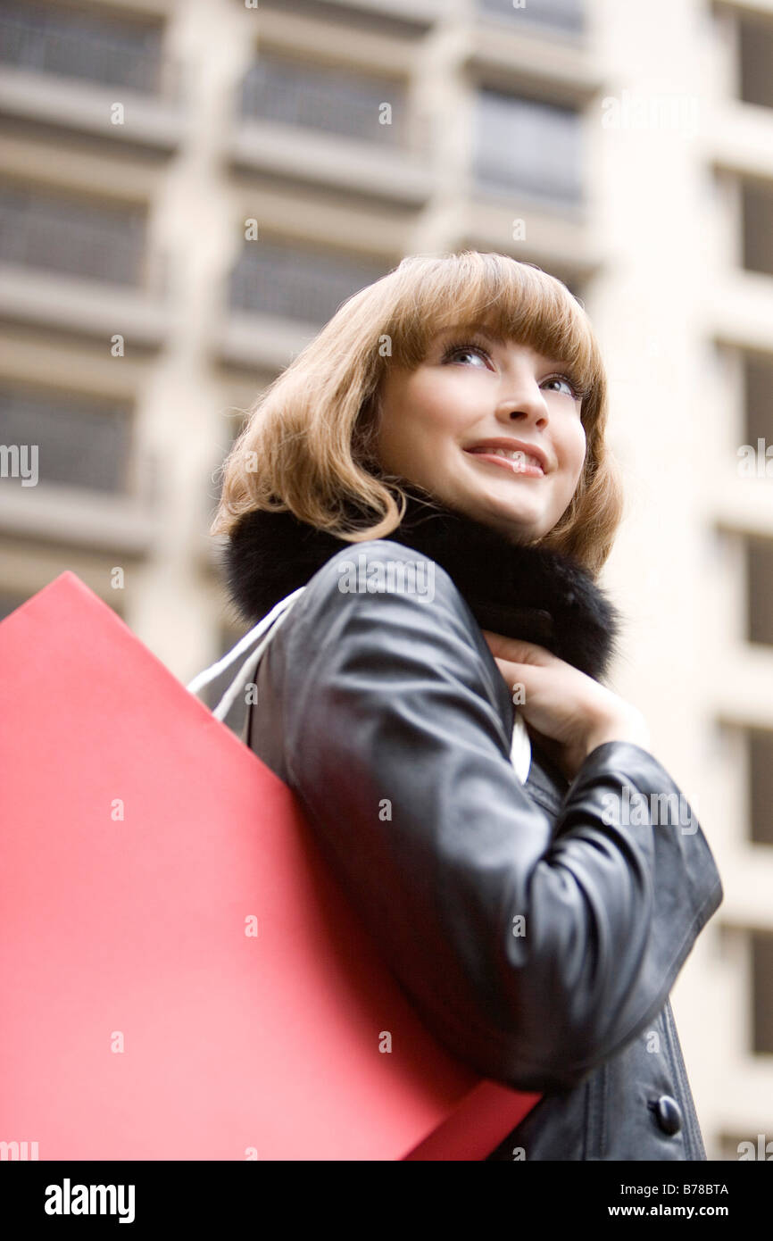 Teenage girl with bag on the shoulder building in the background Stock ...