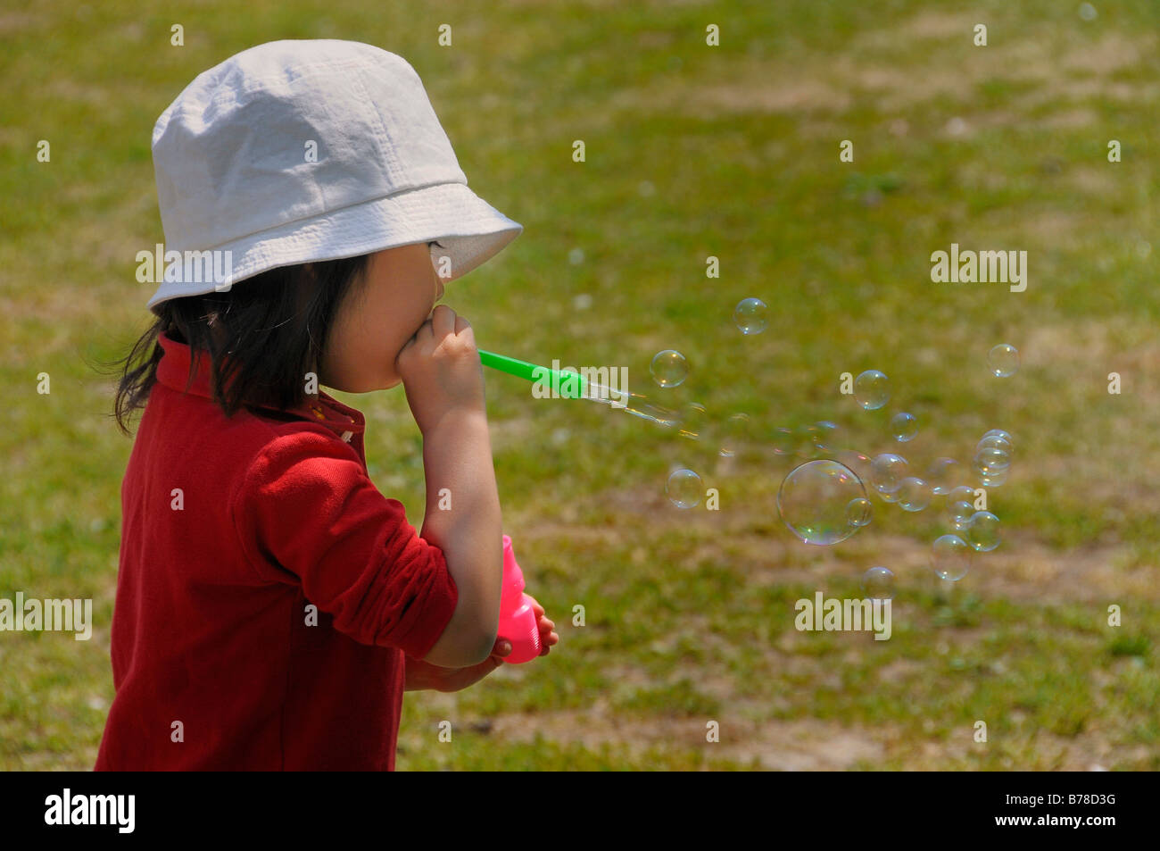 Japanese girl blowing bubbles through a tube, Kyoto, Japan, Asia Stock