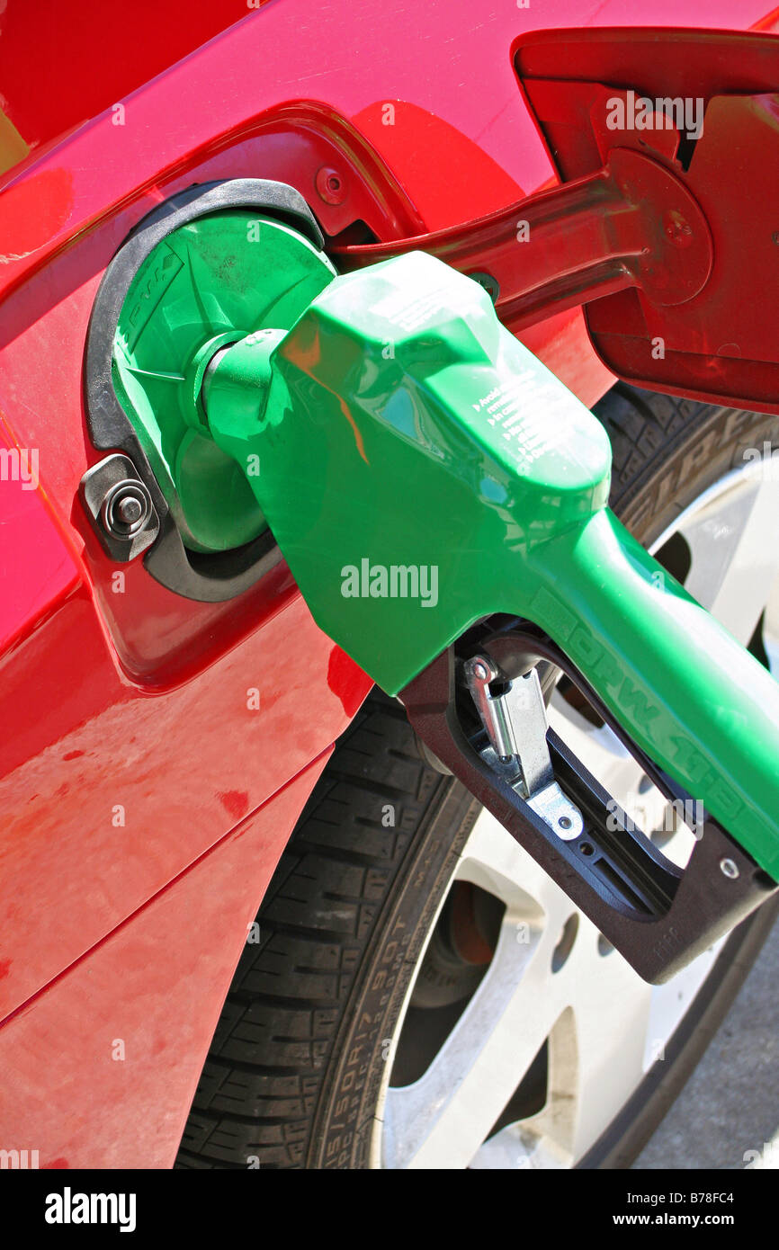 Bright green gas pump in red car Stock Photo Alamy