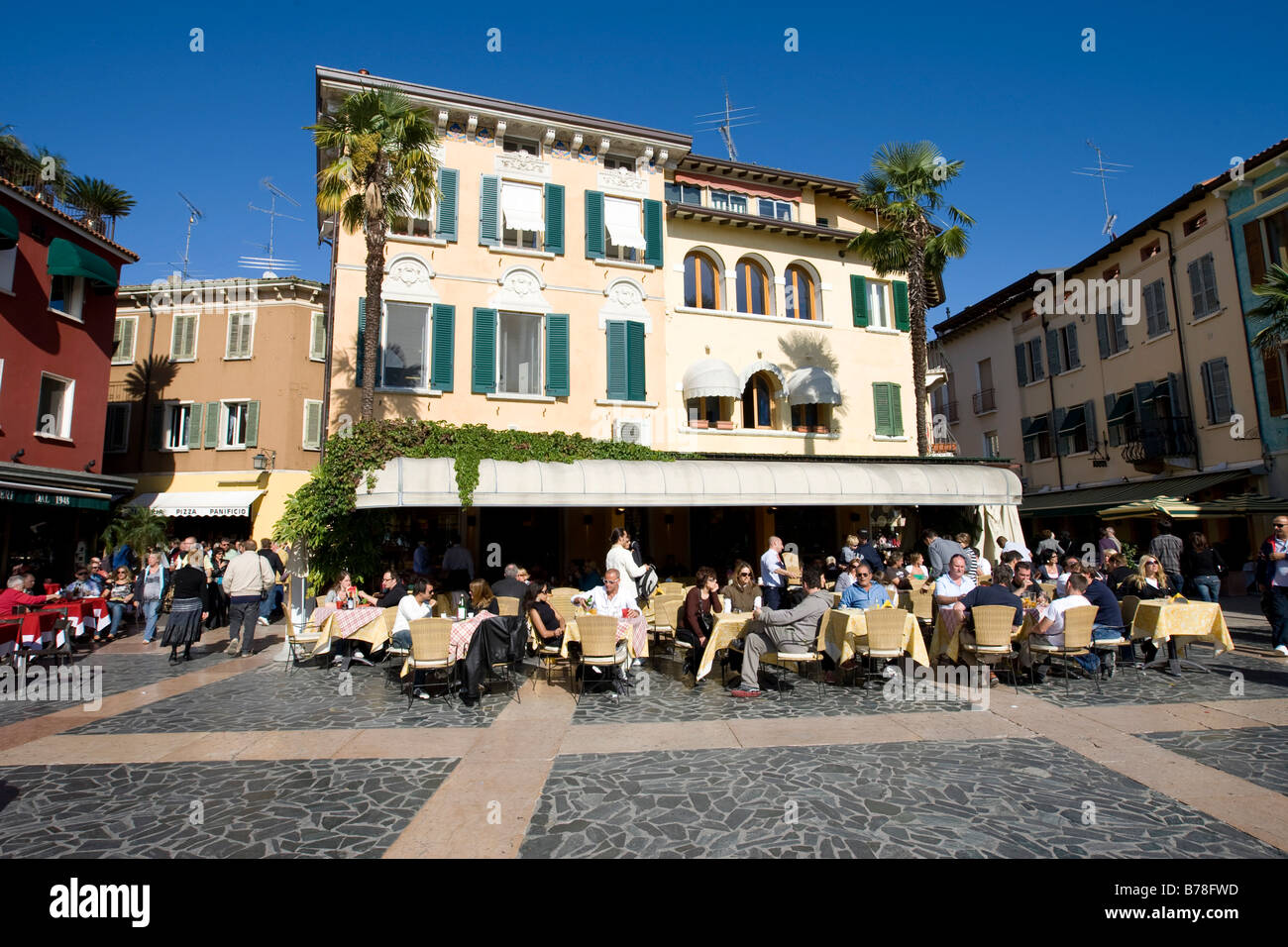 Tourists sitting in a restaurant on the promenade of Sirmione, Lake Garda, Lago di Garda, Lombardy, Italy, Europe Stock Photo