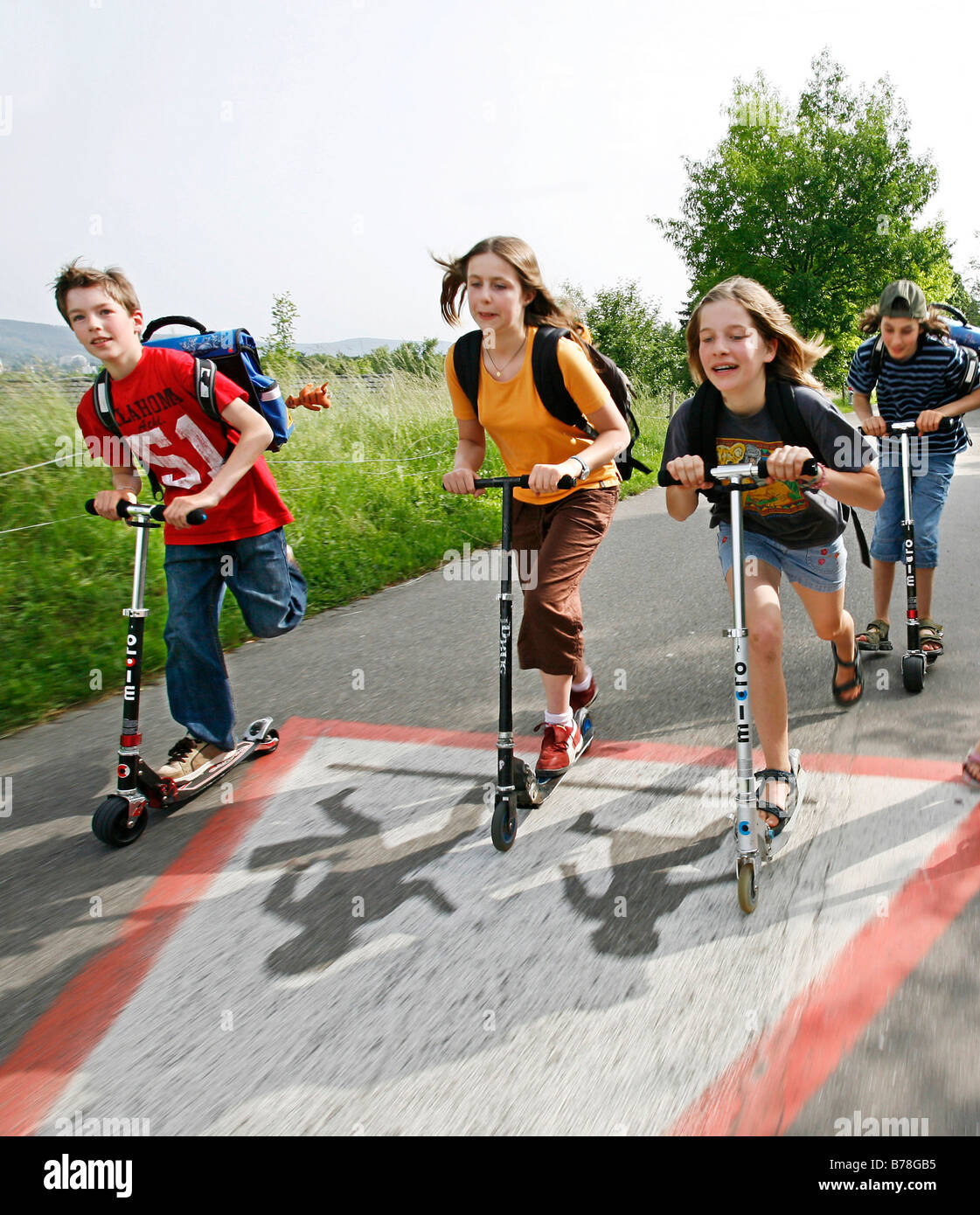 School children, boys and girls, riding kick scooters, push scooters on the  way from school, Basel, Switzerland, Europe Stock Photo - Alamy